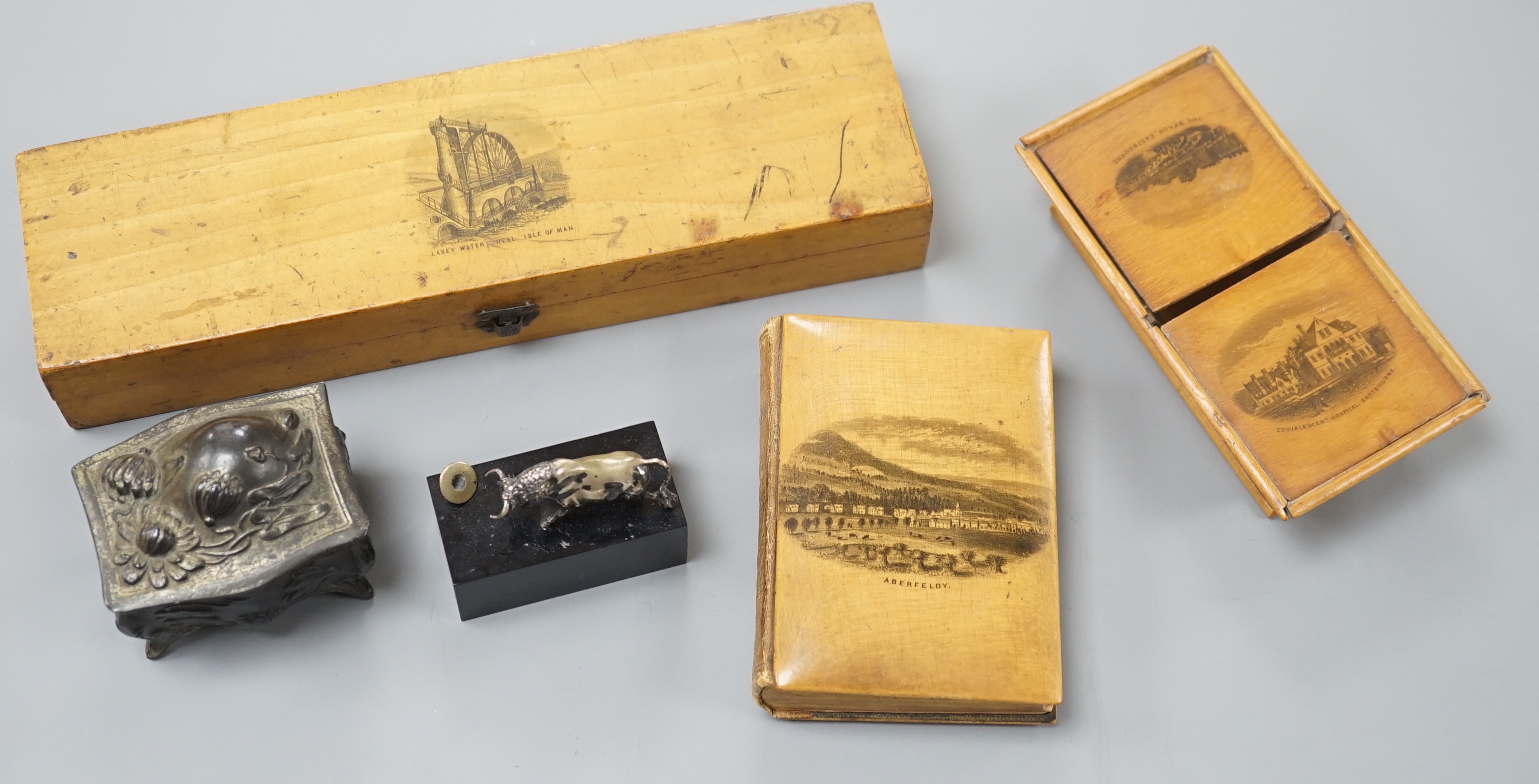 3 Mauchline ware pieces, a metal box and miniature bull on stand, largest box 23cms wide.